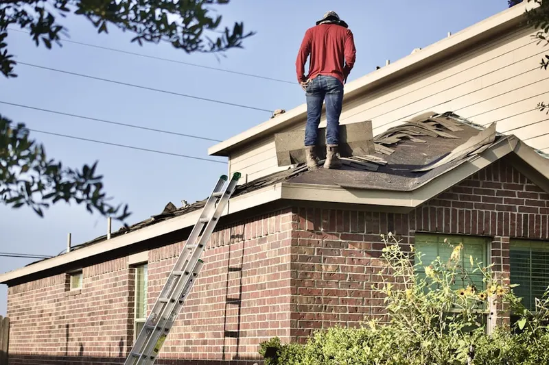 Professional roofer working on a residential roof in Stage Park Meadows